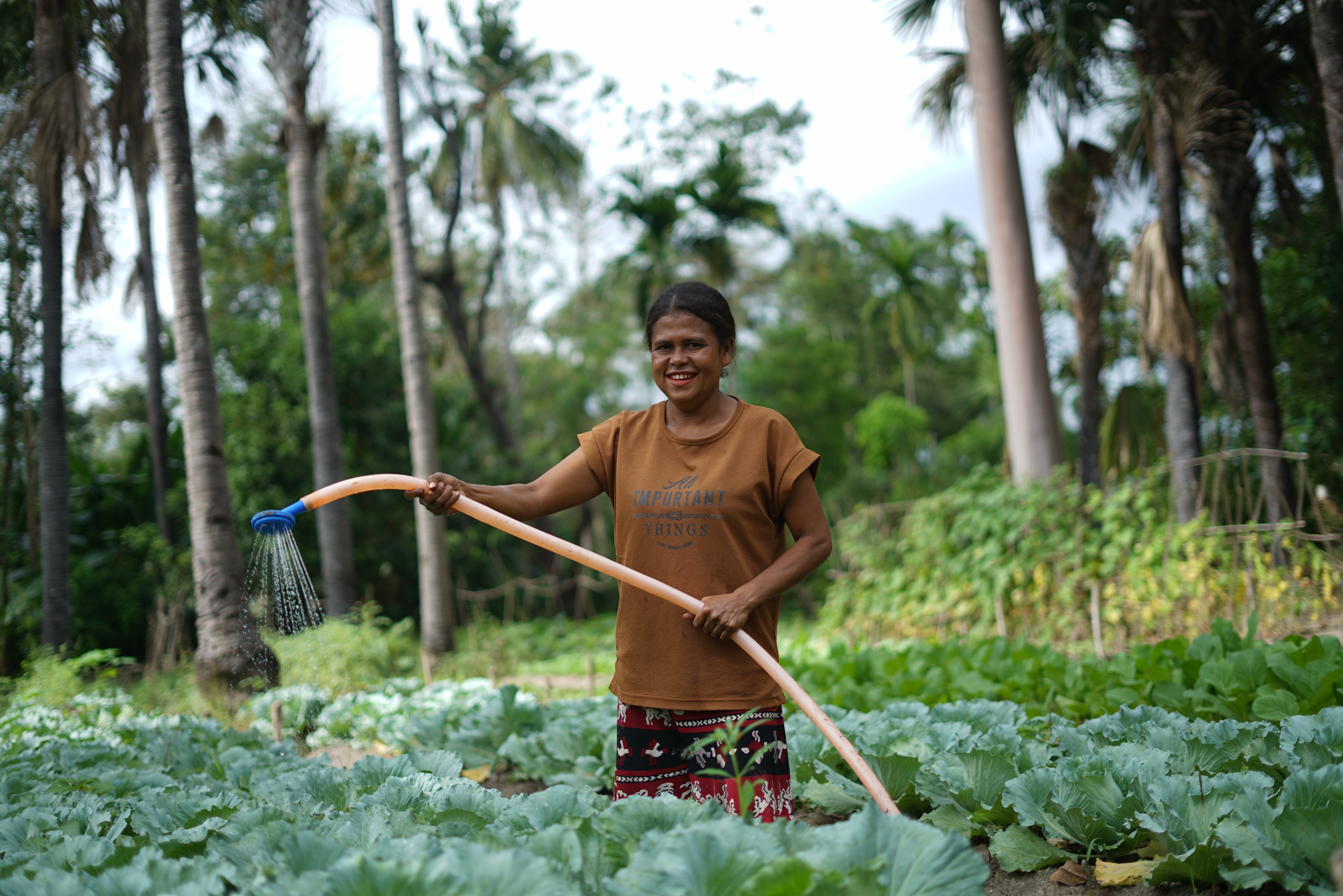Yuniarni watering her crops